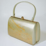 front side of gold-colored kimono clasp handbag