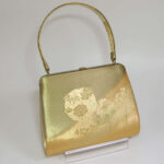 front side of gold strings kimono bag