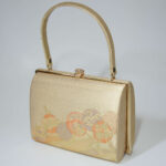 front side of gold strings kimono bag